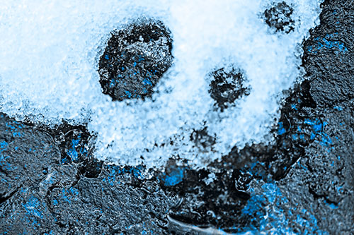 Ice Skull Snow Face Melting Atop Rock (Blue Tone Photo)