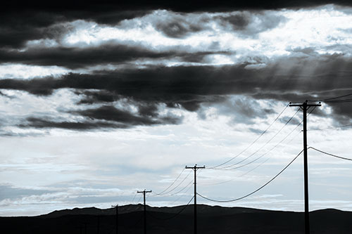 Powerline Silhouette Entering Mountain Range (Blue Tone Photo)