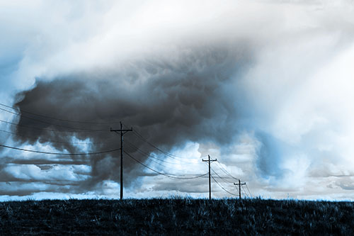 Rainstorm Clouds Twirl Beyond Powerlines (Blue Tone Photo)