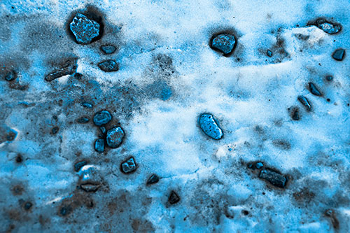 Rocks Forming Smiley Face Atop Snow (Blue Tone Photo)