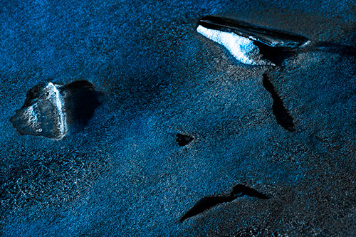 Sad Teardrop Ice Face Appears Atop Frozen River (Blue Tone Photo)
