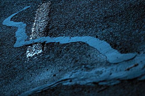 Slithering Tar Creeps Over Pavement Marking (Blue Tone Photo)