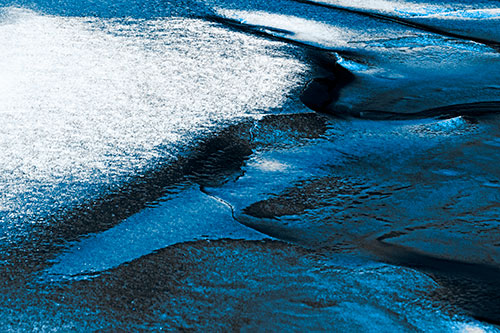 Sloping Ice Melting Atop River Water (Blue Tone Photo)