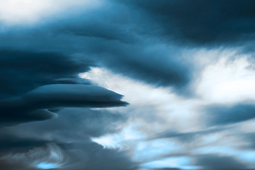 Smooth Cloud Sails Along Swirling Formations (Blue Tone Photo)
