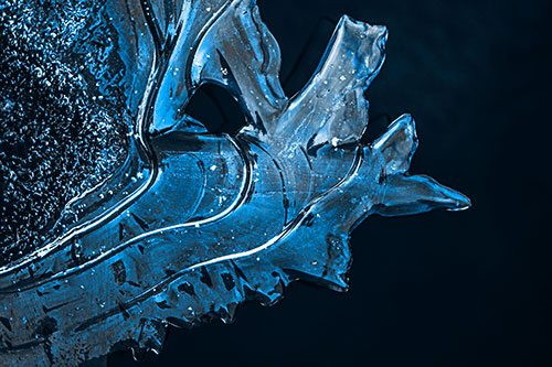 Smooth Ice Face Creature Hanging Above River Shoreline (Blue Tone)