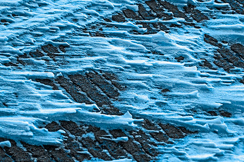 Snow Drifts Atop Rigid Pavement (Blue Tone Photo)