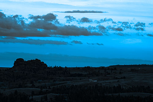 Sunrise Over Rock Formations On The Horizon (Blue Tone Photo)