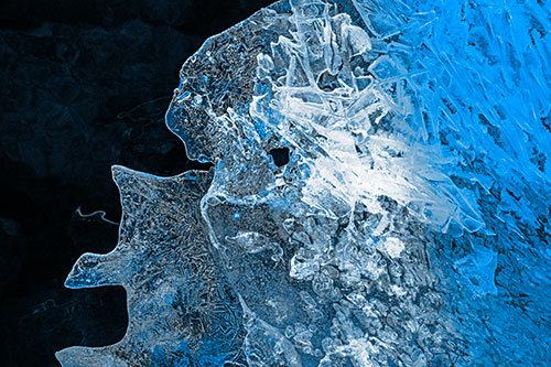 Two Faced Optical Illusion Ice Face Hanging Above River (Blue Tone Photo)