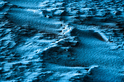 Wind Blowing Across Jagged Frozen Snow Drift (Blue Tone Photo)