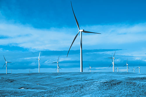 Wind Turbine Cluster Scattered Across Land (Blue Tone Photo)