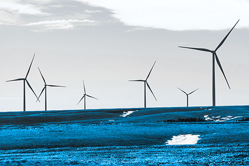 Wind Turbines Scattered Around Melting Snow Patches (Blue Tone Photo)