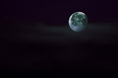 Moon Sets Behind Faint Clouds
