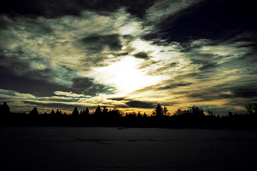 Sun Vortex Illuminates Clouds Above Dark Lit Lake