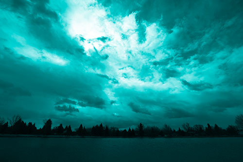 Clouds Spiraling Above Dark Lit Lake (Cyan Shade Photo)
