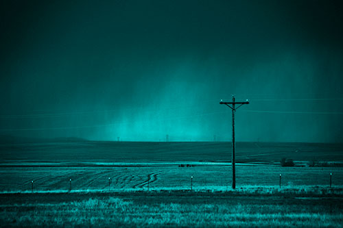 Distant Thunderstorm Rains Down Upon Powerlines (Cyan Shade Photo)