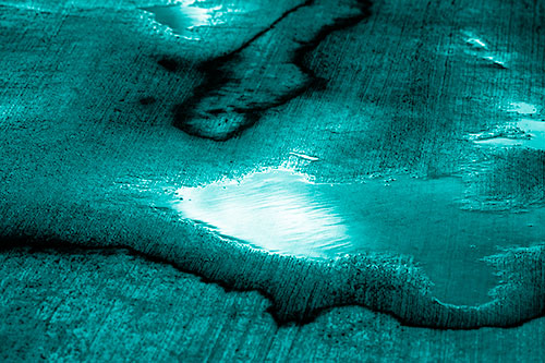 Water Puddles Dissipating After Rainstorm (Cyan Shade Photo)