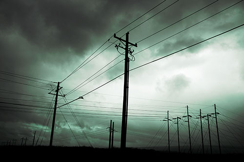 Crossing Powerlines Beneath Rainstorm (Cyan Tint Photo)