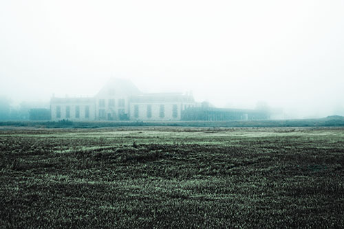 Dense Fog Consumes Distant Historic State Penitentiary (Cyan Tint Photo)