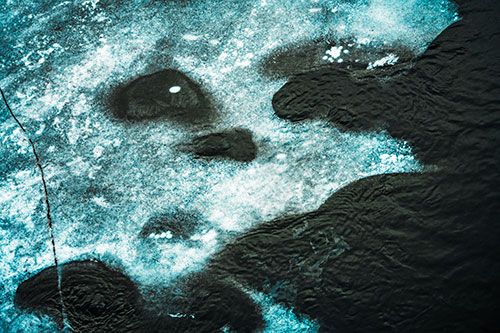 Disintegrating Ice Face Melting Among Flowing River Water (Cyan Tint Photo)