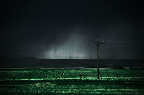 Distant Thunderstorm Rains Down Upon Powerlines (Cyan Tint Photo)