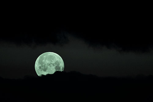 Easter Morning Moon Peeking Through Clouds (Cyan Tint Photo)