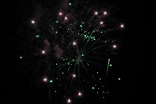 Firework Light Orbs Free Falling After Explosion (Cyan Tint Photo)