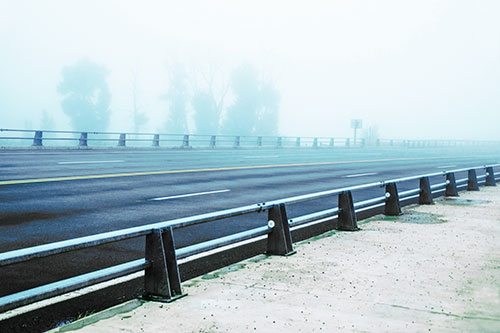Fog Surrounds Deserted Sidewalk Roadway (Cyan Tint Photo)