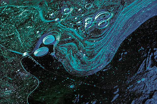 Frozen Bubble Clusters Among Twirling River Ice (Cyan Tint Photo)