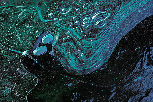 Frozen Bubble Clusters Among Twirling River Ice (Cyan Tint)