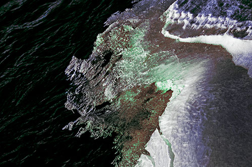 Melting Ice Face Creature Atop River Water (Cyan Tint Photo)