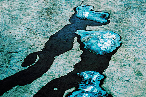 Melting Ice Puddles Forming Water Streams (Cyan Tint Photo)