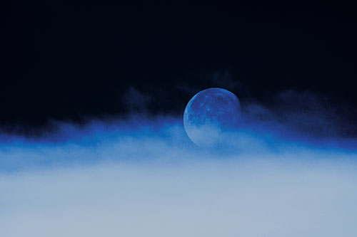 Moon Rolling Along Clouds (Cyan Tint Photo)