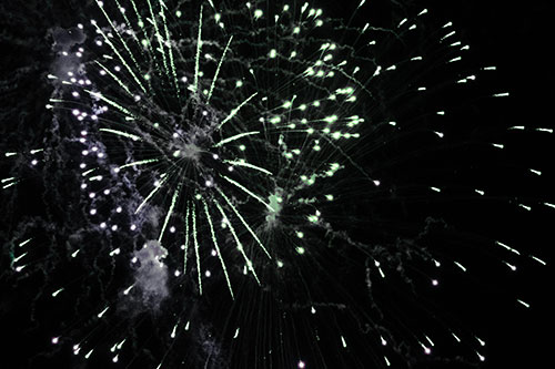 Multiple Firework Explosions Send Light Orbs Flying (Cyan Tint Photo)