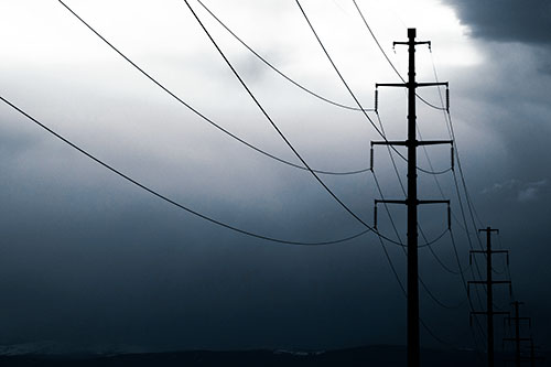 Powerlines Receding Into Thunderstorm (Cyan Tint Photo)