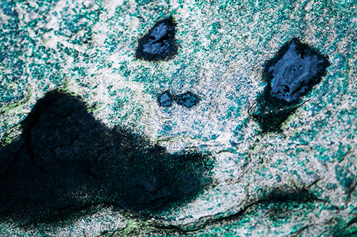 Shocked Puddle Face Drying Among Rock Surface (Cyan Tint Photo)