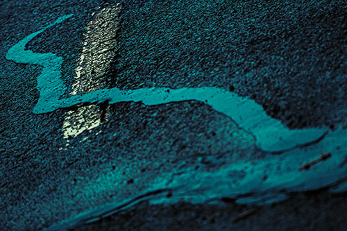 Slithering Tar Creeps Over Pavement Marking (Cyan Tint Photo)
