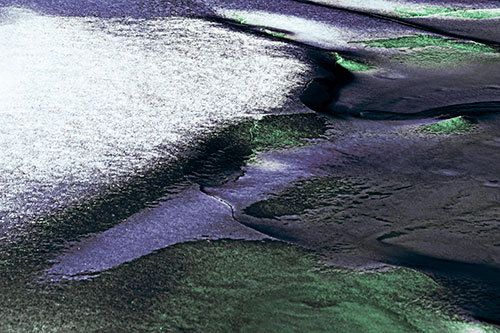 Sloping Ice Melting Atop River Water (Cyan Tint Photo)