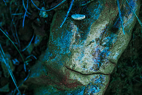 Smirking Battered Rock Face (Cyan Tint Photo)