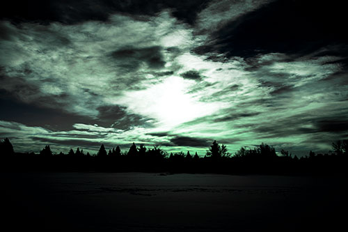Sun Vortex Illuminates Clouds Above Dark Lit Lake (Cyan Tint Photo)