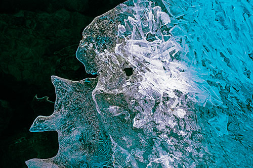 Two Faced Optical Illusion Ice Face Hanging Above River (Cyan Tint Photo)