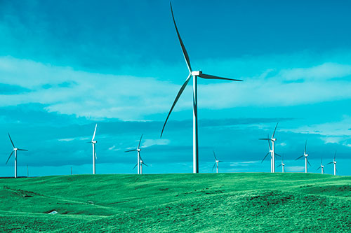 Wind Turbine Cluster Scattered Across Land (Cyan Tint Photo)