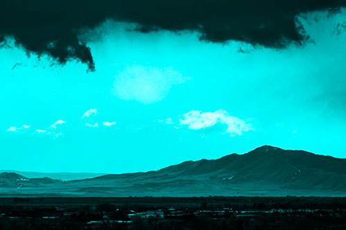 Dark Cloud Mass Above Mountain Range Horizon (Cyan Tone Photo)