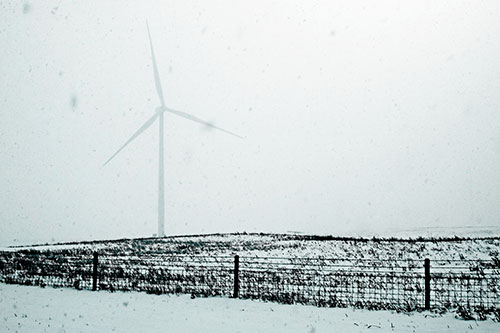 Fenced Wind Turbine Among Blowing Snow (Cyan Tone Photo)
