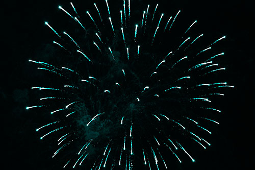 Firework Star Trails Vaporize Among Night Sky (Cyan Tone Photo)