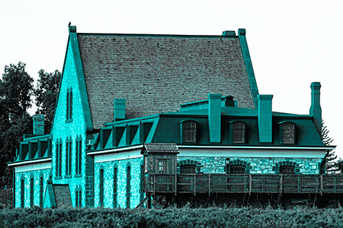 Hawk Sits Atop Gabled State Penitentiary Roof (Cyan Tone Photo)
