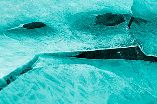 Rock Face Emerges Among Cracked Frozen Ice (Cyan Tone)