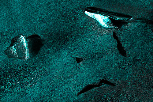 Sad Teardrop Ice Face Appears Atop Frozen River (Cyan Tone Photo)