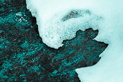 Screaming Snow Face Slowly Melting Atop Rock Surface (Cyan Tone)