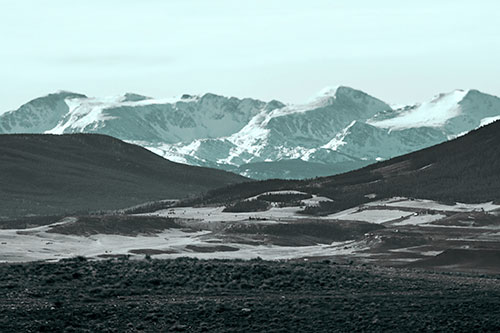 Snow Capped Mountains Behind Hills (Cyan Tone Photo)