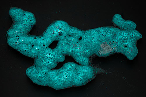Sorrow Morphing Bubble Face Floating Above Soil (Cyan Tone)